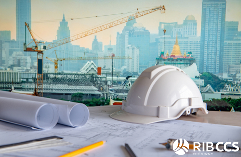 Hard hat with construction plans on a desk